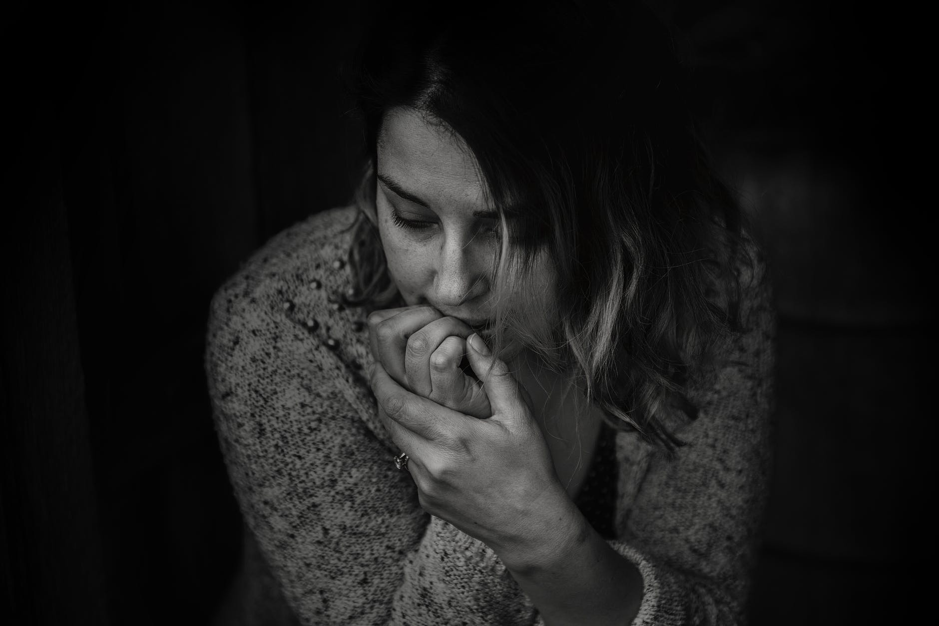 greyscale photography of woman wearing long sleeved top