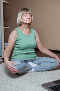 woman meditating at home on floor