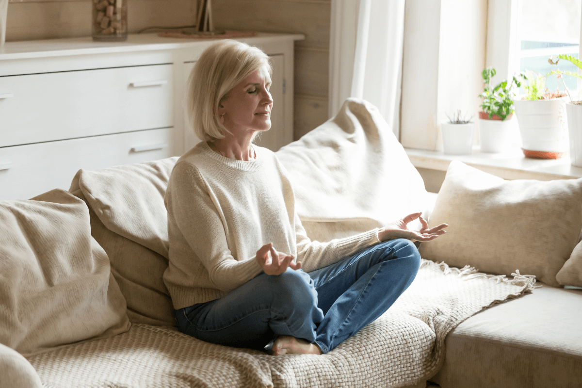 woman on couch meditating